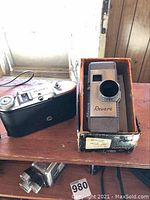 Voigtländer Bessa I camera body alongside Revere 8mm movie camera in original box.
