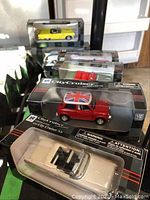 Photo showing multiple model cars in original City Cruiser collection packaging, including a yellow car and a boxed 1957 Pontiac Bonneville convertible.