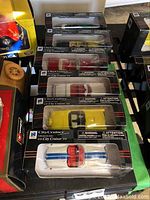 Six City Cruiser model cars in original boxes lined up on a flat surface, showing packaging and some car details.