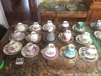 Photo showing the entire collection of 15 teacups with saucers arranged