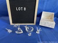 Full view of all six glass and crystal miniatures along with the white floral storage case.