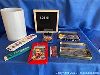 Wide shot of all items from the students/artists lot arranged on blue cloth background with LOT 51 sign.