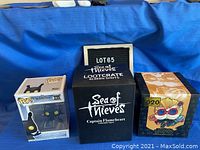 Three boxed collectible figures including Shadow Heartless Funko Pop vinyl figure, Sea of Thieves Captain Flameheart Lootcrate figure, and League of Legends Heimerdinger figure.