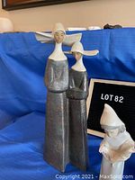 Two Lladro porcelain nun figurines standing side by side