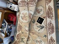 Full view of rug folded to show overall design and motifs