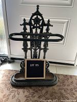 Full front view of umbrella stand with removable drip tray and lot sign