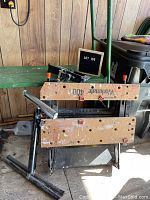 Black & Decker Workmate 400 portable wooden-jaw workbench folded, showing wear and paint markings.