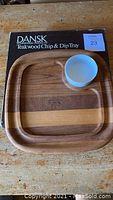 Top-down view of the teakwood chip and dip tray with the white ceramic bowl placed inside the recessed area.