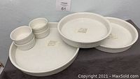 Set of white porcelain ramekins of various sizes displayed together on table