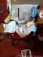 Assorted pillow cases and sheets in various colors and folded on a chair