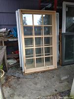 Front view of a wood-finish window with 4×4 muntin grid