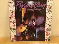 Front cover of Prince's Purple Rain vinyl LP with a motorcycle image and purple colored title text.