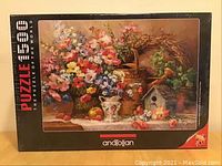 Front view of the Anatolian 1500 piece jigsaw puzzle box featuring the artwork of a floral still life titled Potpourri Garden Medley.