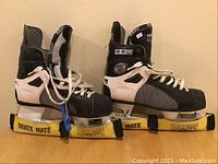 Pair of CCM 700 Tacks men's hockey skates size 8 with skate guards and lace tightener