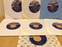 Photo showing seven 45 RPM vinyl singles with Motown label and MCA branded sleeves