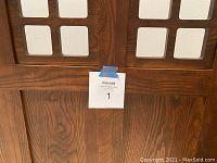 Close-up of the solid oak wood grain and structure on the headboard showing the Mission style design and some signs of edge wear.