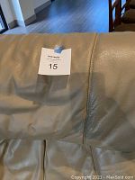 Close-up of the beige leather upholstery showing texture and condition.