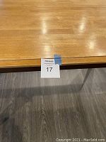 Close-up of the table surface showing the wood grain, finish, and wear marks.