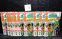 Front view of ten identical comic book issues lined up against a black background