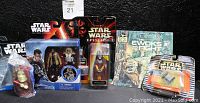 All six Star Wars collectible items displayed together, showing packaging and condition.