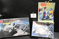 Two boxed AMT Batman model kits and a Model and Toy Collector magazine arranged together.