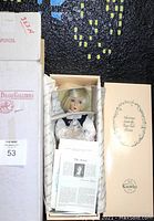 Original box opened showing the doll inside with paperwork and packaging.