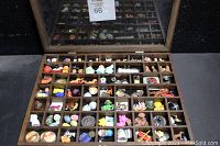 Full view of vintage miniature collectibles organized in wooden display case sections