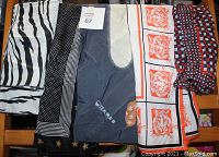 Photo showing all six vintage women's scarves laid out in a row, showcasing various prints including tiger designs, geometric squares, and multi-color patterns.