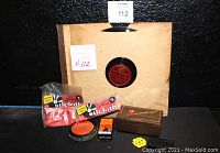 Four RCA Victor Red Seal 78 RPM vinyl records in paper sleeves with red labels, arranged alongside various vintage record-related accessories including cleaning cloths, record cleaner, wooden box, and cartridge box.