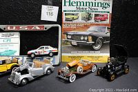 Full lot including six die-cast vintage replica cars, two USA Surfer license plate holders, CPI value guide, Hemmings Motor News magazine.