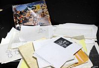 Lot of assorted animation paper sheets and printed animation images spread out.
