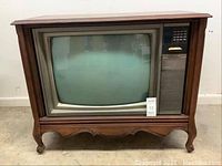 Front view of vintage Electrohome 25-inch TV in a wood cabinet with controls on the right.