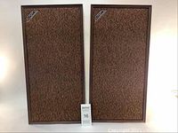 Front view of the pair of Audio Craftsmen vintage speakers showing fabric grille and logo.