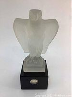 Front view of the frosted crystal eagle sculpture on black base with Bohemian label.