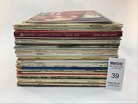 Stack of over 50 vinyl records showing various album spines with some readable titles such as 'Mascagni Cavalleria Rusticana'