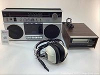 Full lot including Akai stereo radio cassette recorder, RCA headphones with damaged cord, and 8 track player.