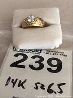 Ring displayed on white foam block with lot number tag visible
