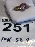 Ring displayed in a white box with lot tag showing number 251 and “10K sz 8” handwritten.