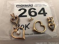 All five charms in sealed plastic bag on MaxSold lot label.