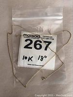 Full view of the 10k gold 18 inch neck chain in a plastic bag with sale tag