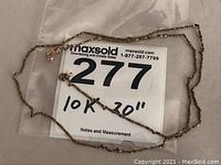 Full view of the 20 inch 10k gold chain laid out on a surface showing the entire length and style of the chain.