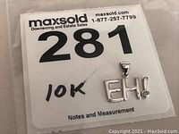 Pendant alongside lot number label stating 10k gold.