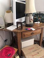 Photo of wood corner desk showing drawer, wood grain, and items on desk not included in sale