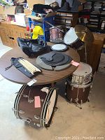 Overhead view of drums, cymbals, sticks on table and floor