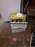 Box containing eight new LED dimmable retrofit light kits in original packaging, unopened and organized vertically inside the box.