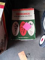 Box labeled 'Brunswick Ice Skate Outfit' with vintage sports illustrations