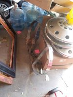 Photo of the hanging pot rack on the floor with chains and metal circular frame
