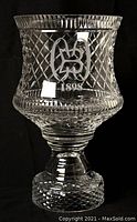 Side view of large heavy cut crystal vase, showing Baltimore Country Club logo etched on the front.