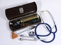 Main photo showing the vintage doctor's kit including the stethoscope, ENT light, reflex hammer, and tuning fork with the brown carrying case open