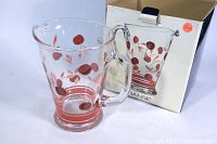 Clear glass pitcher with red and brown Bing Cherries design and original box in background, shown from the front.
